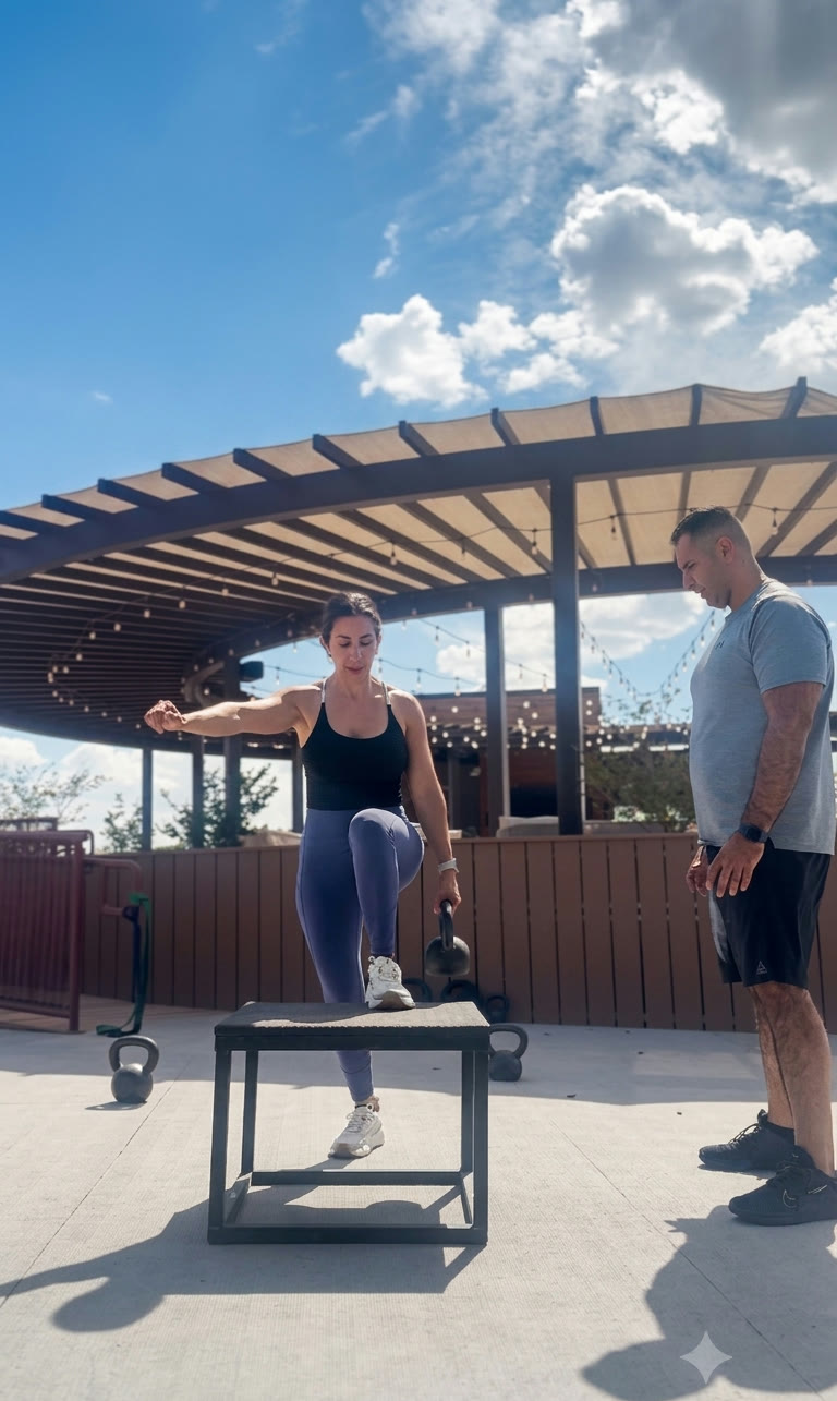 Dr. Andrew Cisneros, PT, DPT, MS coaching Celeste Cisneros, FNP-BC on kettlebell single-leg step-up loading at their outdoor training space in El Paso, TX — the integrated care partnership in action
