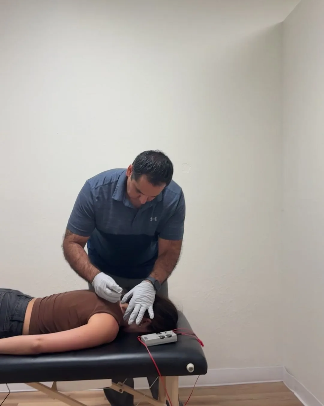 Dr. Andrew Cisneros, PT, DPT performing electrical dry needling with e-stim leads attached at Solas Physical Therapy, 300 N Resler Dr, El Paso TX