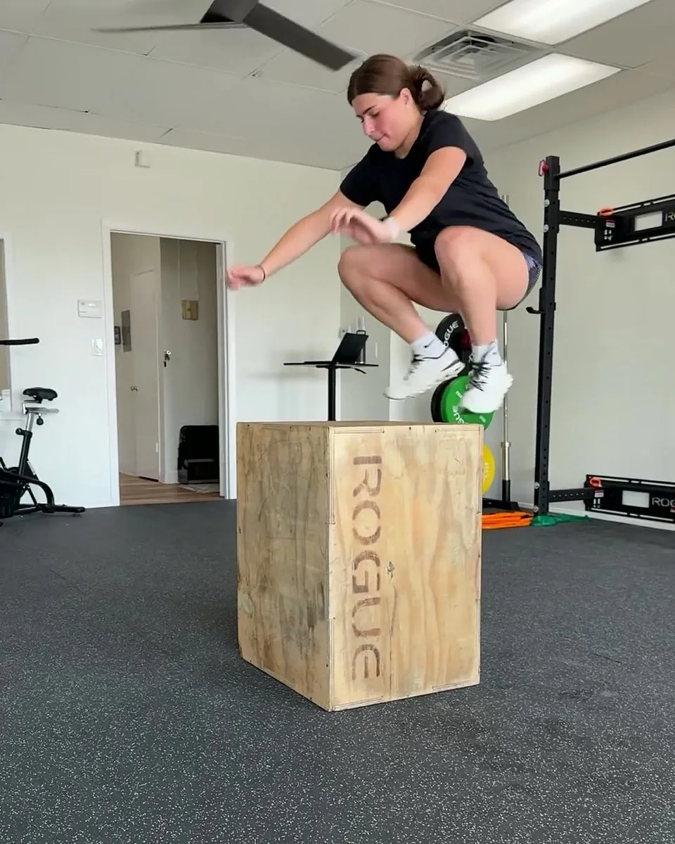 Athlete mid-flight in a plyometric box jump during return-to-sport training at Solas Physical Therapy, 300 N Resler Dr, El Paso TX